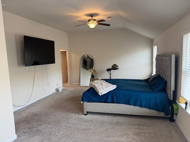 bedroom featuring lofted ceiling, ceiling fan, and carpet flooring