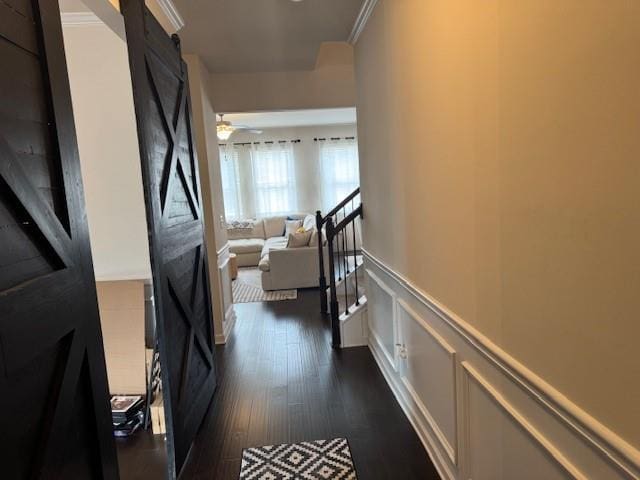 corridor with ornamental molding and dark hardwood / wood-style floors