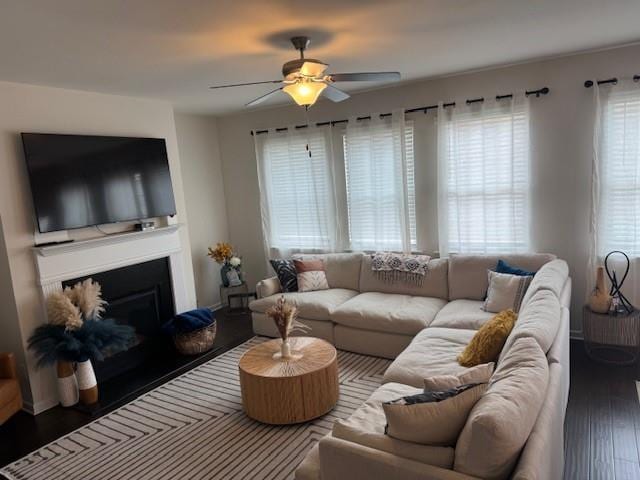 living room with dark hardwood / wood-style flooring, plenty of natural light, and ceiling fan