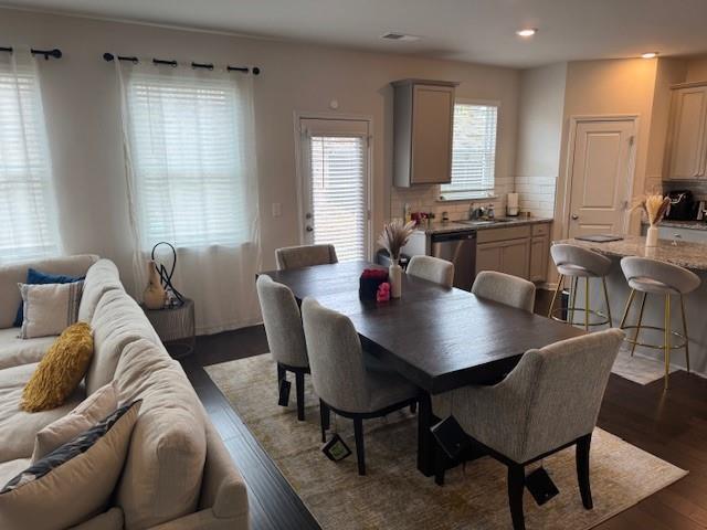 dining room with dark wood-type flooring and sink