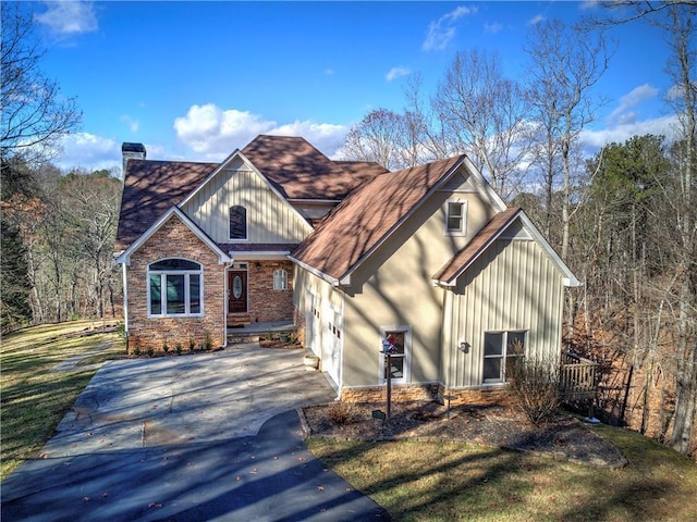 view of front of house with a garage and a front lawn