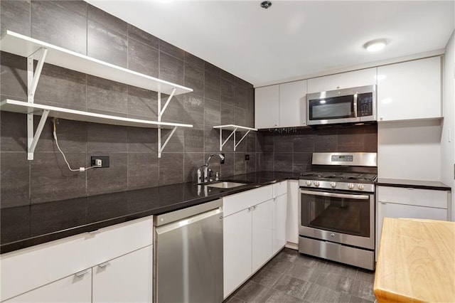 1501 Clairmont Rd Unit 1522, Decatur, GA 30033 - kitchen with stainless steel appliances, open shelves, white cabinets, and tasteful backsplash