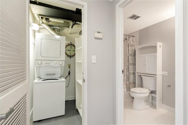 1501 Clairmont Rd Unit 1522, Decatur, GA 30033 - bathroom featuring stacked washing machine and dryer and toilet