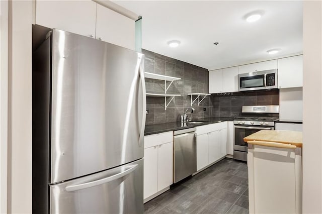 1501 Clairmont Rd Unit 1522, Decatur, GA 30033 - kitchen with appliances with stainless steel finishes, backsplash, and white cabinets