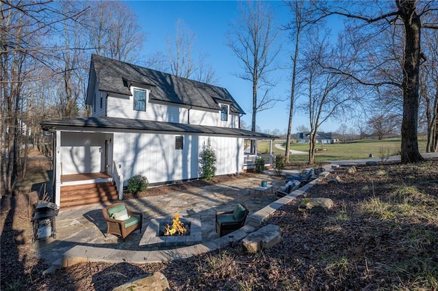 29 Highpoint Ridge Ct, Ellijay, GA 30536 - rear view of house with a shingled roof, an outdoor fire pit, and a patio