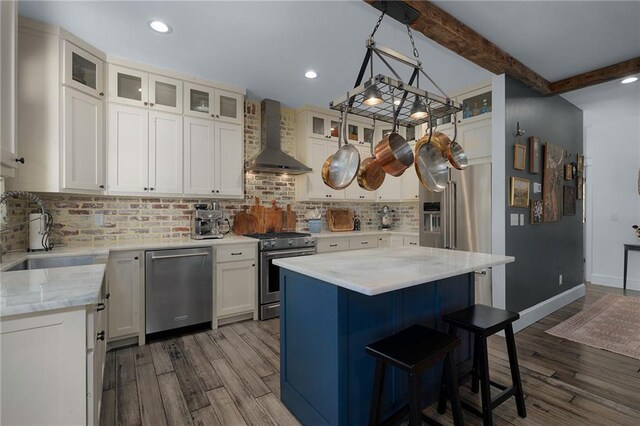 29 Highpoint Ridge Ct, Ellijay, GA 30536 - kitchen with premium appliances, beam ceiling, a sink, a kitchen island, and wall chimney exhaust hood