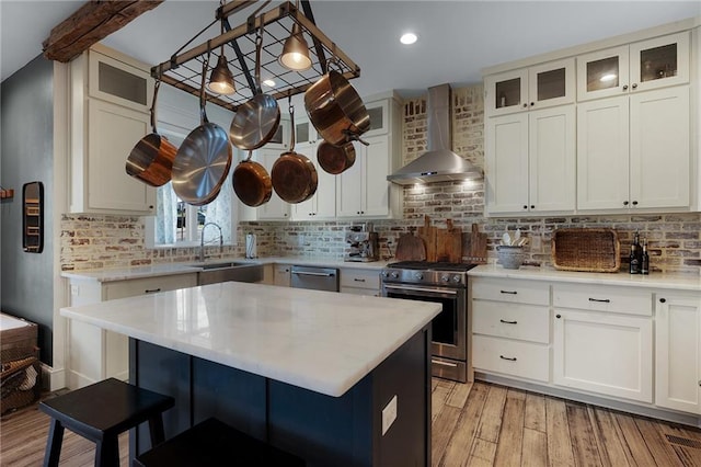 29 Highpoint Ridge Ct, Ellijay, GA 30536 - kitchen with wall chimney exhaust hood, appliances with stainless steel finishes, a kitchen breakfast bar, light countertops, and a sink