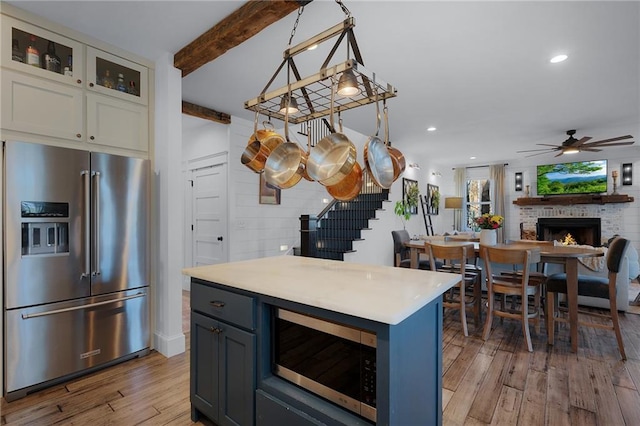 29 Highpoint Ridge Ct, Ellijay, GA 30536 - kitchen with beam ceiling, stainless steel appliances, recessed lighting, light countertops, and wood finished floors
