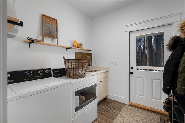 29 Highpoint Ridge Ct, Ellijay, GA 30536 - washroom with separate washer and dryer, a sink, baseboards, light wood-type flooring, and cabinet space