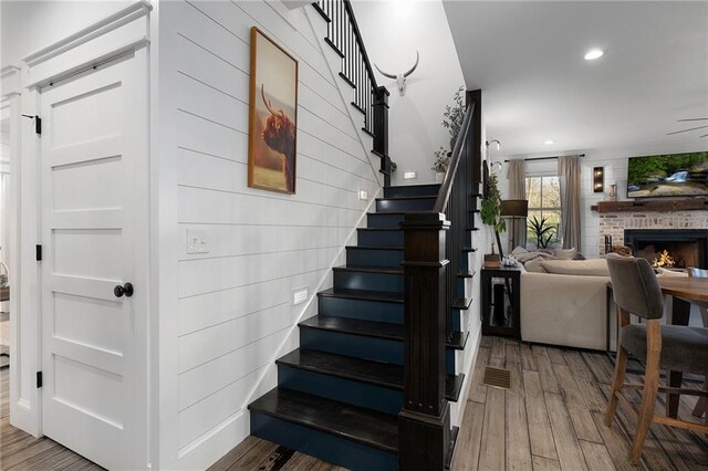 29 Highpoint Ridge Ct, Ellijay, GA 30536 - stairway with a fireplace, wood finished floors, and recessed lighting
