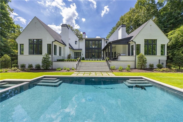 back of property featuring a yard and a sunroom