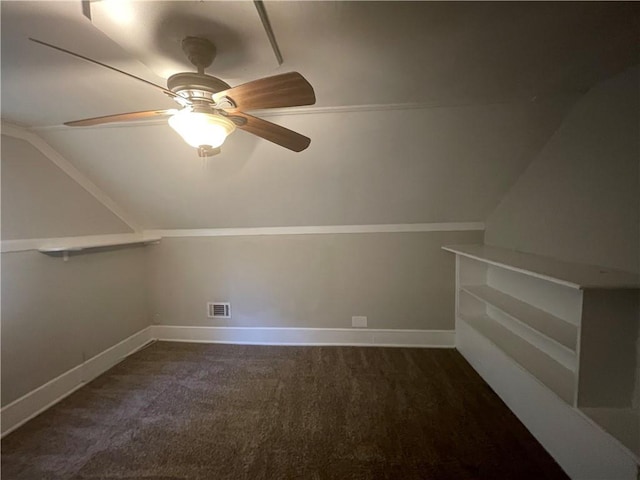 bonus room with dark colored carpet, vaulted ceiling, and ceiling fan