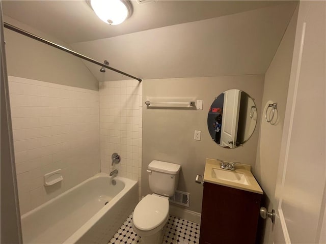 full bathroom featuring tile patterned floors, vanity, tiled shower / bath combo, and toilet