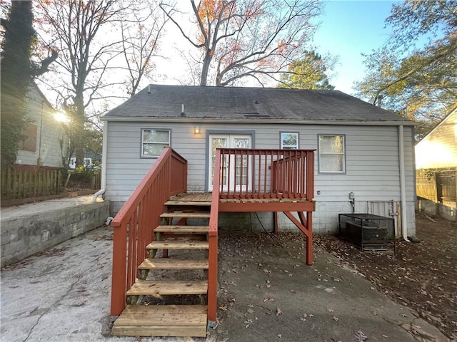 rear view of house featuring a deck and central AC unit