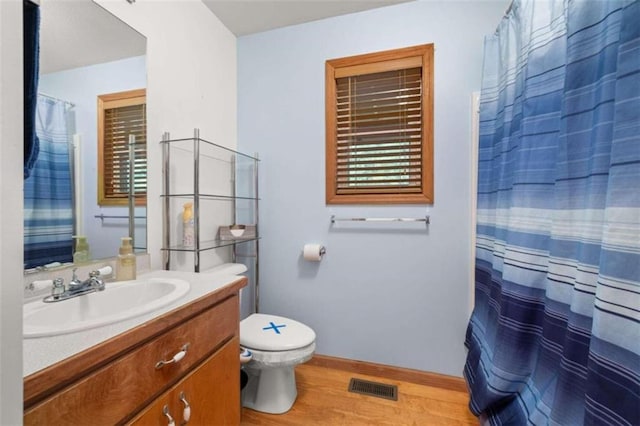 bathroom featuring hardwood / wood-style floors, vanity, and toilet