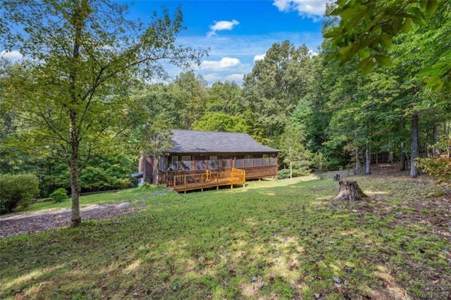 view of yard with a sunroom and a wooden deck