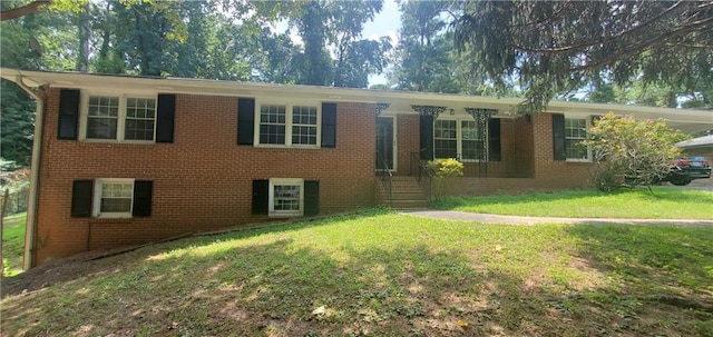 single story home featuring brick siding and a front yard