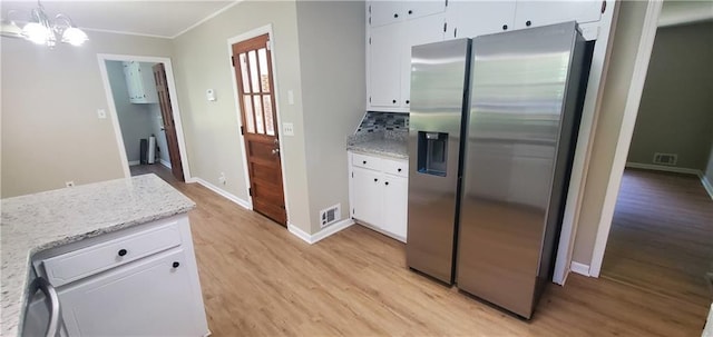 kitchen with white cabinets, stainless steel fridge with ice dispenser, visible vents, and light wood-style flooring