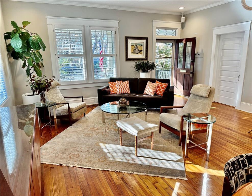 living room featuring hardwood / wood-style floors and ornamental molding