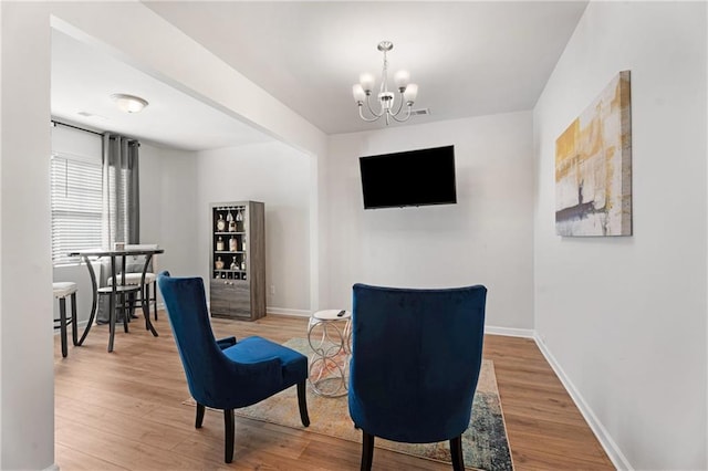 living area with a chandelier and hardwood / wood-style floors