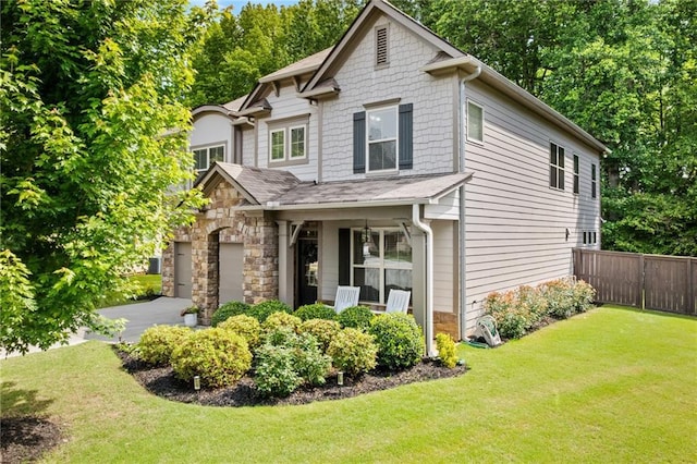 view of front facade featuring a garage, covered porch, stone siding, and driveway