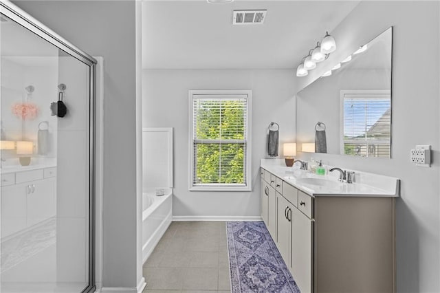 full bath featuring tile patterned flooring, double vanity, a stall shower, a bath, and baseboards