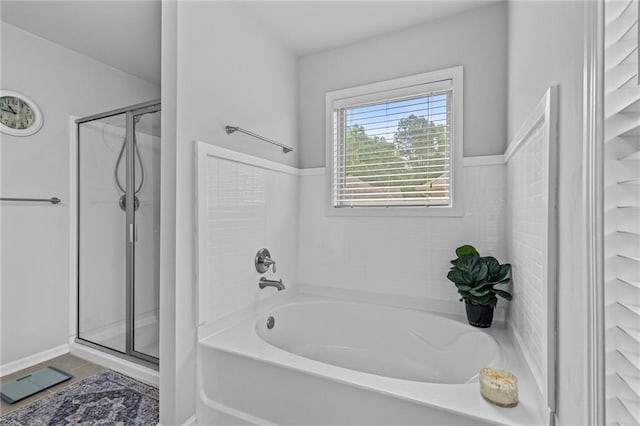 bathroom with a shower stall, a garden tub, and tile patterned flooring