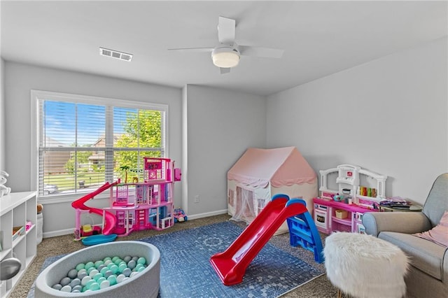 recreation room with plenty of natural light, carpet flooring, baseboards, and a ceiling fan