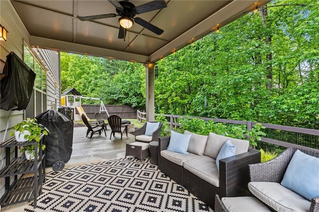 wooden deck featuring an outdoor hangout area, a ceiling fan, a playground, fence, and a patio area