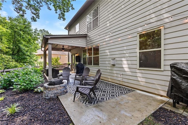 view of patio / terrace with an outdoor fire pit and a ceiling fan