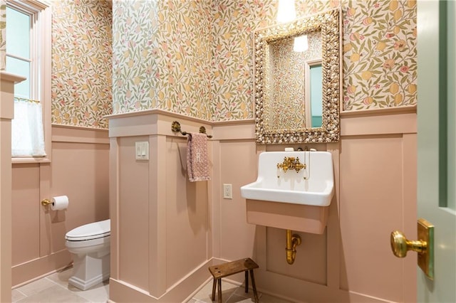 bathroom featuring tile patterned flooring, toilet, and wallpapered walls