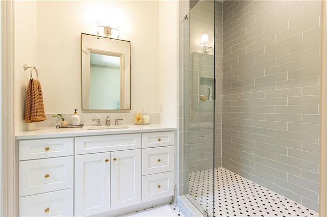 full bath featuring vanity and tiled shower