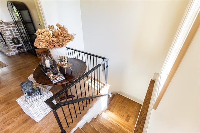 stairway featuring baseboards and wood finished floors