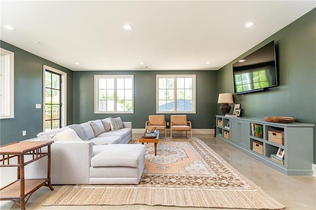living area featuring recessed lighting, baseboards, and a wealth of natural light