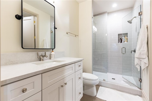 full bath featuring vanity, tile patterned floors, toilet, and a shower stall