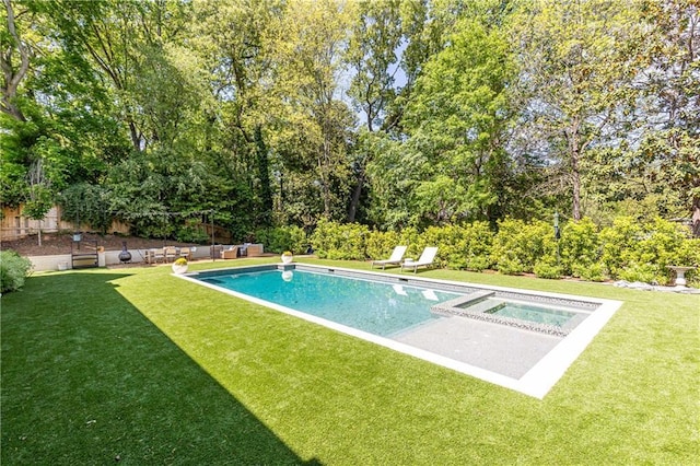 view of swimming pool with a lawn, a fenced in pool, and an in ground hot tub