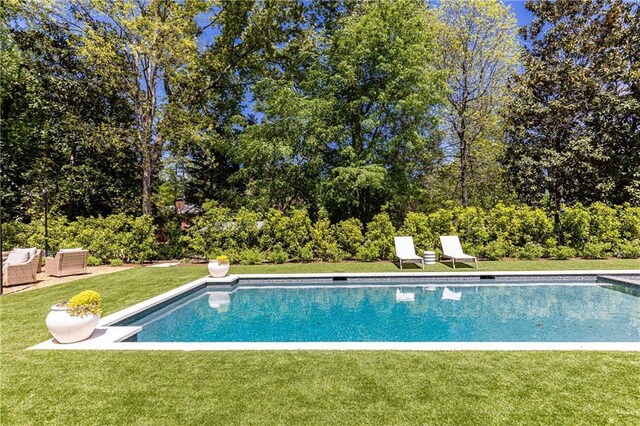 pool with a lawn and an outdoor living space