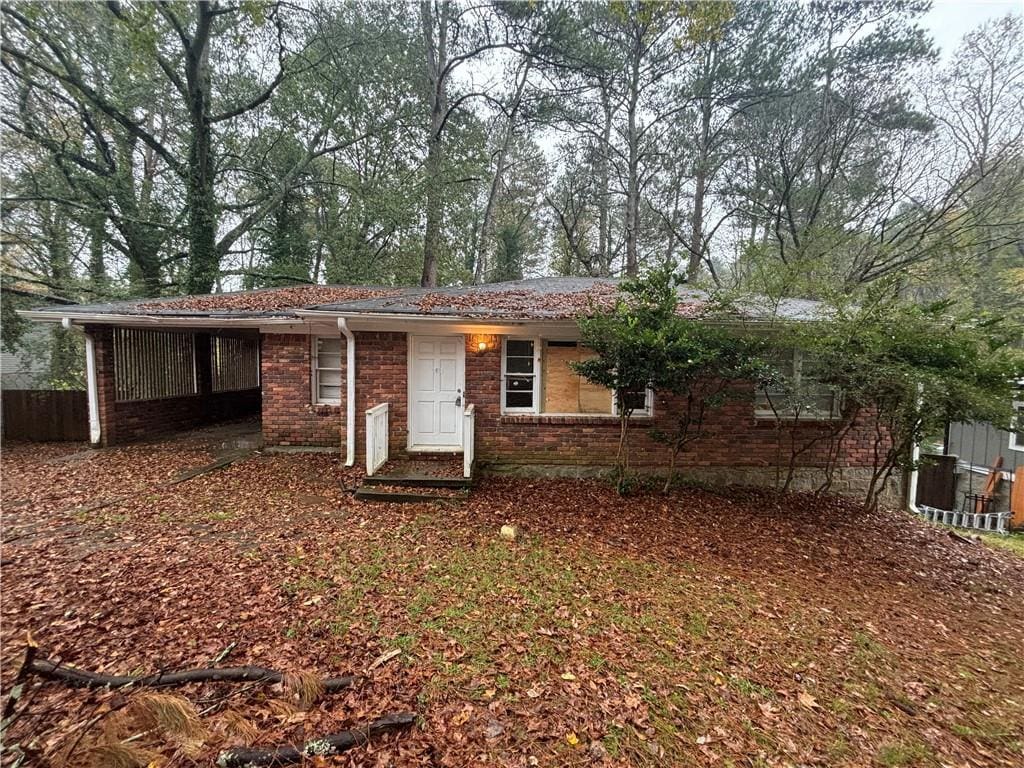 single story home featuring a carport