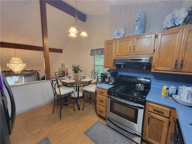 3723 Raiders Ridge Dr, Lithonia, GA 30038 - kitchen featuring stainless steel range with gas stovetop, a chandelier, ventilation hood, light wood-style floors, and light countertops