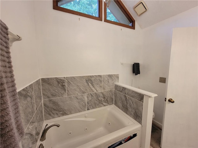 3723 Raiders Ridge Dr, Lithonia, GA 30038 - full bath featuring a whirlpool tub, vaulted ceiling, and toilet