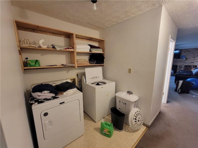 3723 Raiders Ridge Dr, Lithonia, GA 30038 - laundry area featuring washing machine and dryer, a textured ceiling, light carpet, and a fireplace