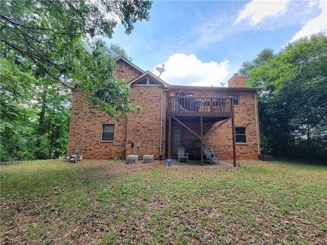 3723 Raiders Ridge Dr, Lithonia, GA 30038 - back of property featuring brick siding, a chimney, a lawn, and a deck