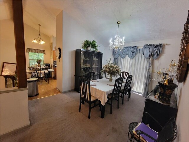 3723 Raiders Ridge Dr, Lithonia, GA 30038 - carpeted dining room featuring a chandelier and vaulted ceiling