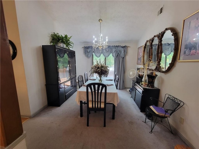 3723 Raiders Ridge Dr, Lithonia, GA 30038 - dining space featuring a chandelier, a textured ceiling, and carpet floors