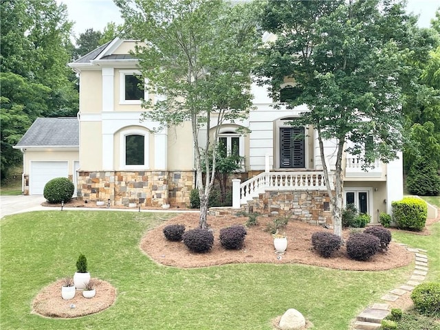 view of front of property with a garage and a front lawn