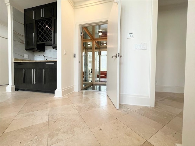 corridor featuring sink and ornamental molding