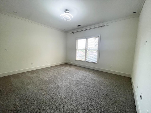 unfurnished room with dark carpet and crown molding