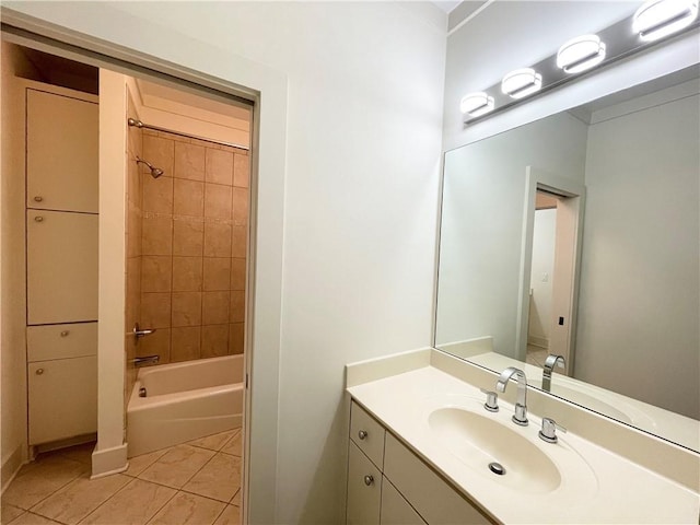 bathroom with tile patterned floors, vanity, and tiled shower / bath