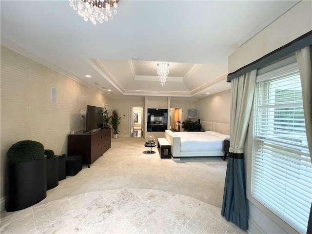 bedroom with ornamental molding, light carpet, a tray ceiling, and a chandelier