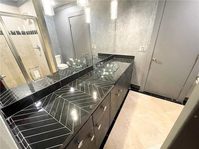 kitchen with dark brown cabinets, light tile patterned floors, and sink